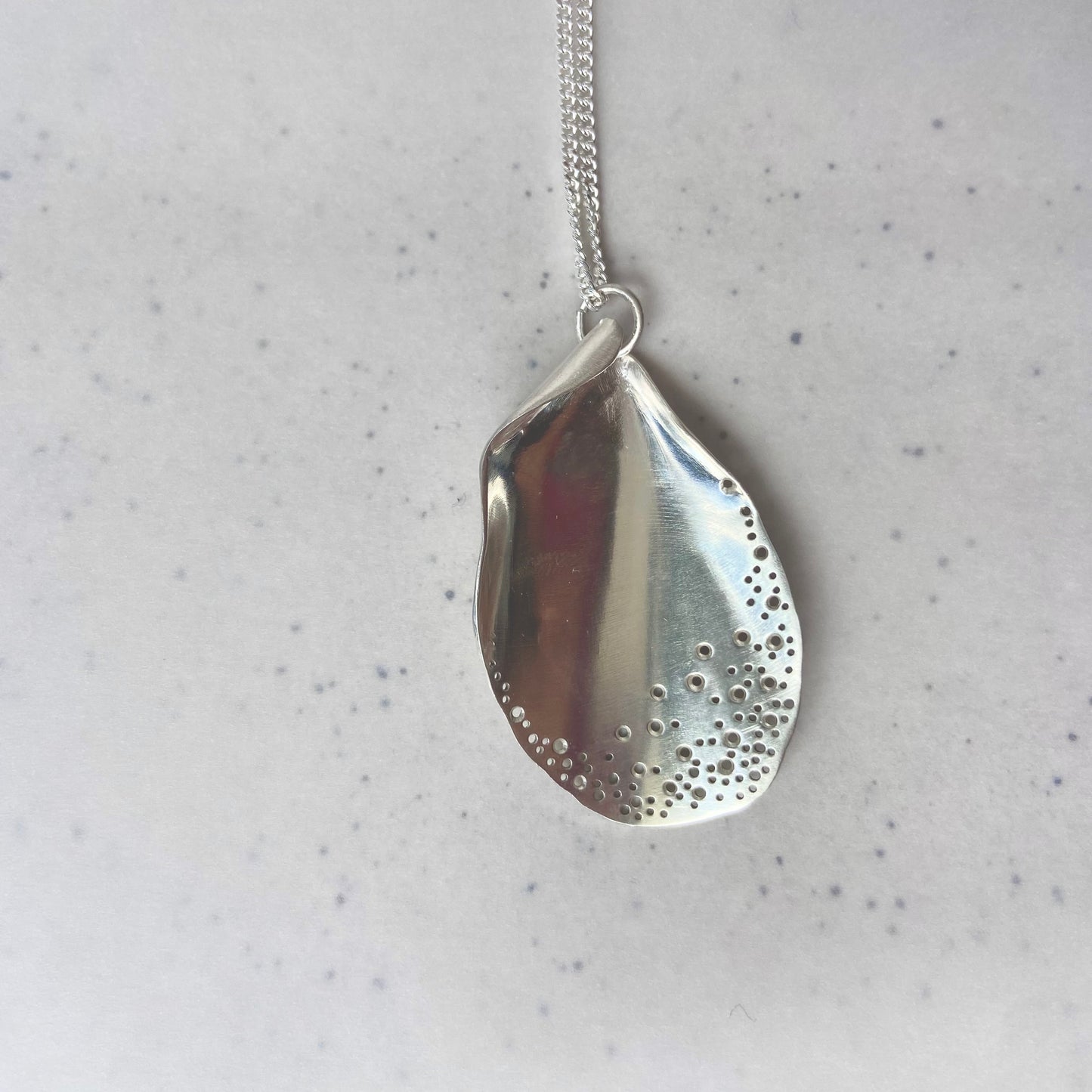 Long oyster-inspired, hand-fabricated, silver pendant and chain