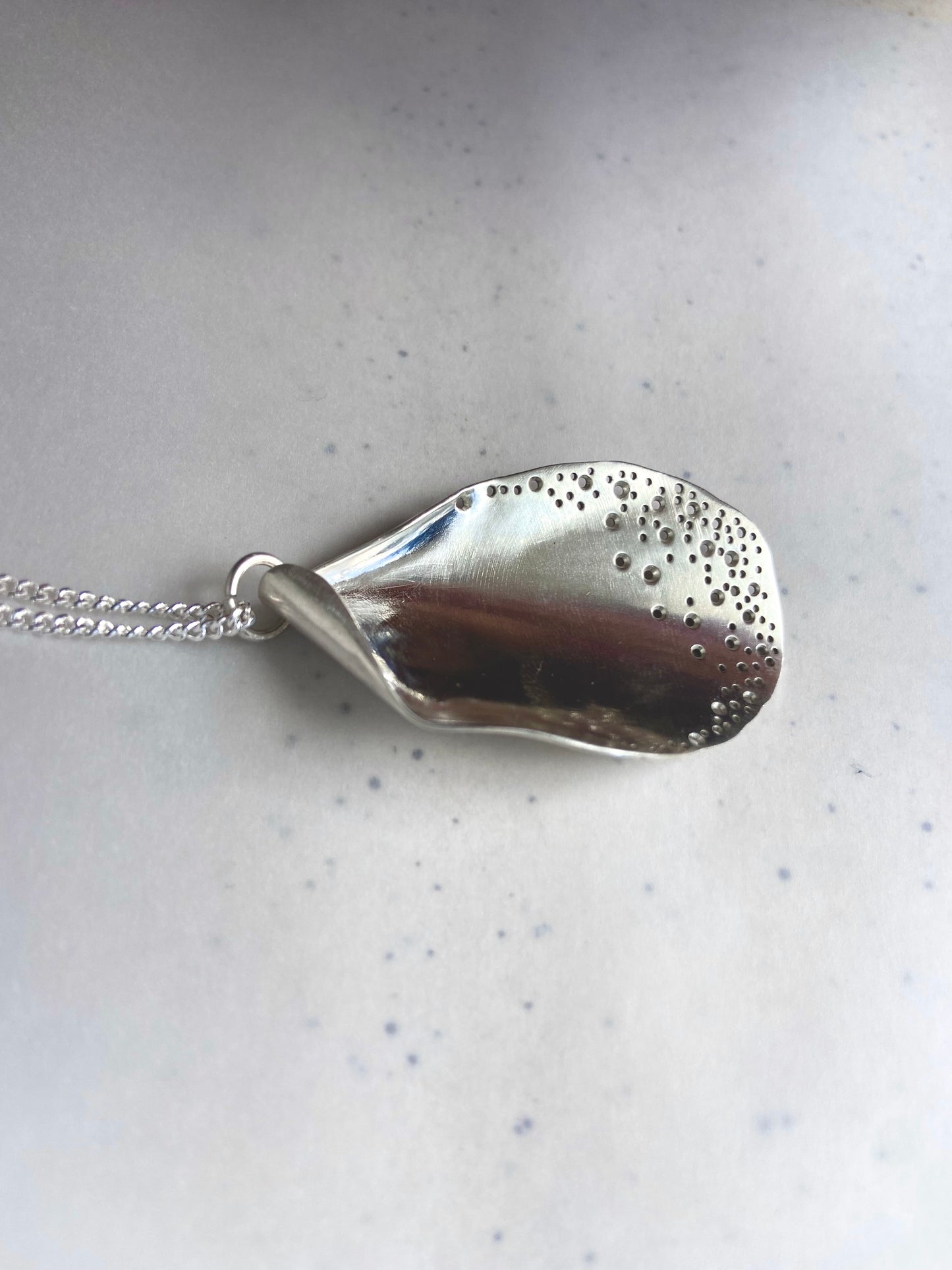 Long oyster-inspired, hand-fabricated, silver pendant and chain