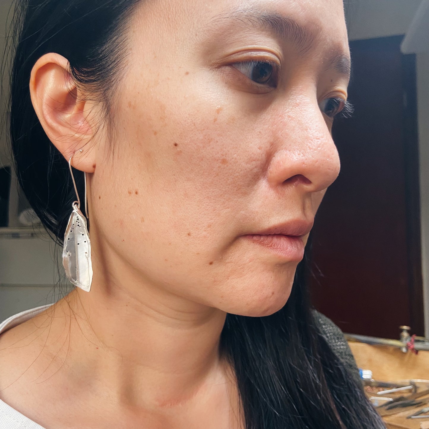 Silver cicada wing earrings.