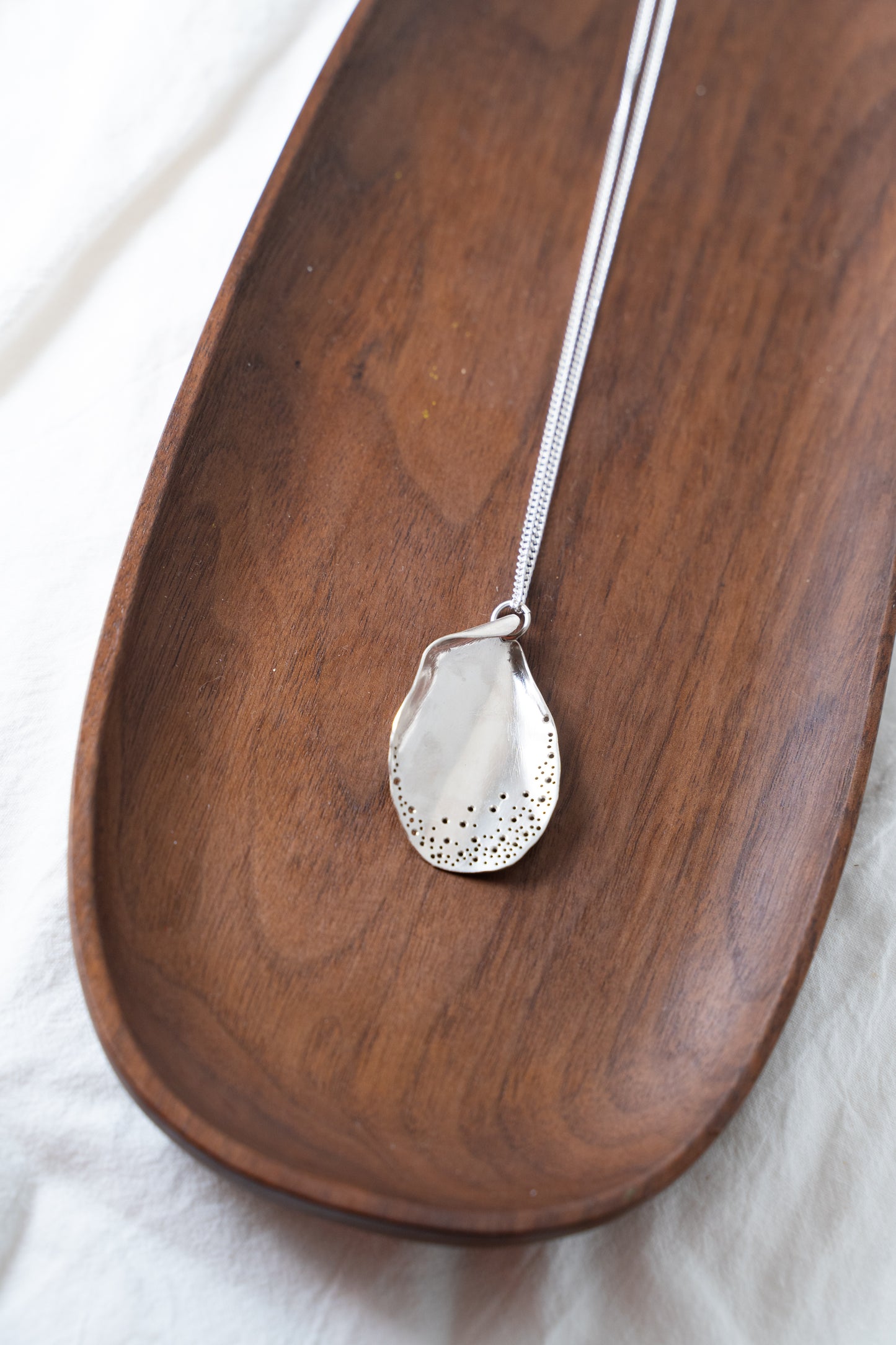 Long oyster-inspired, hand-fabricated, silver pendant and chain