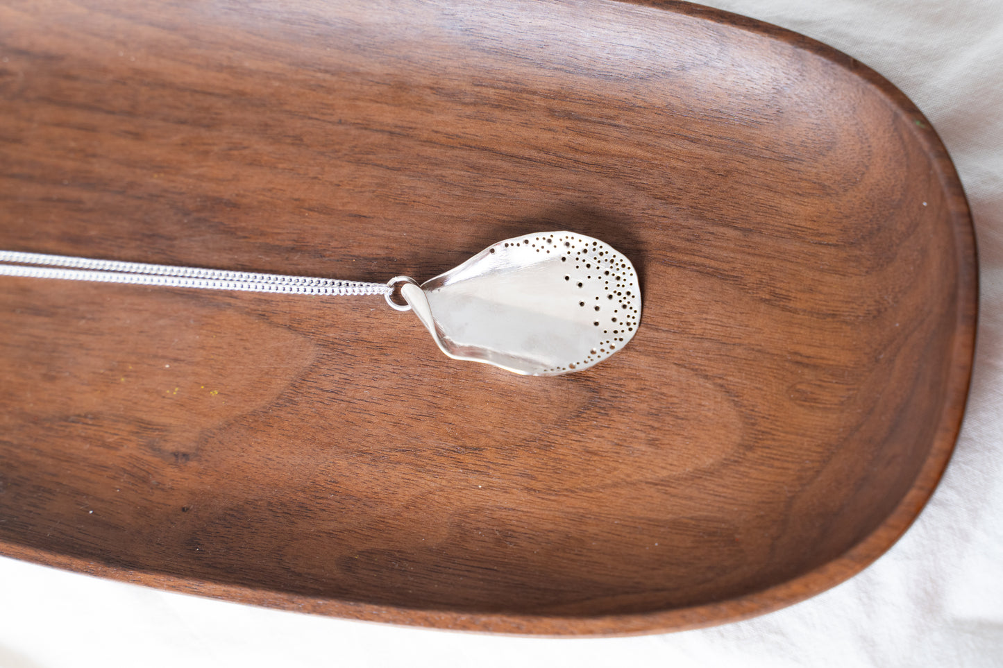 Long oyster-inspired, hand-fabricated, silver pendant and chain