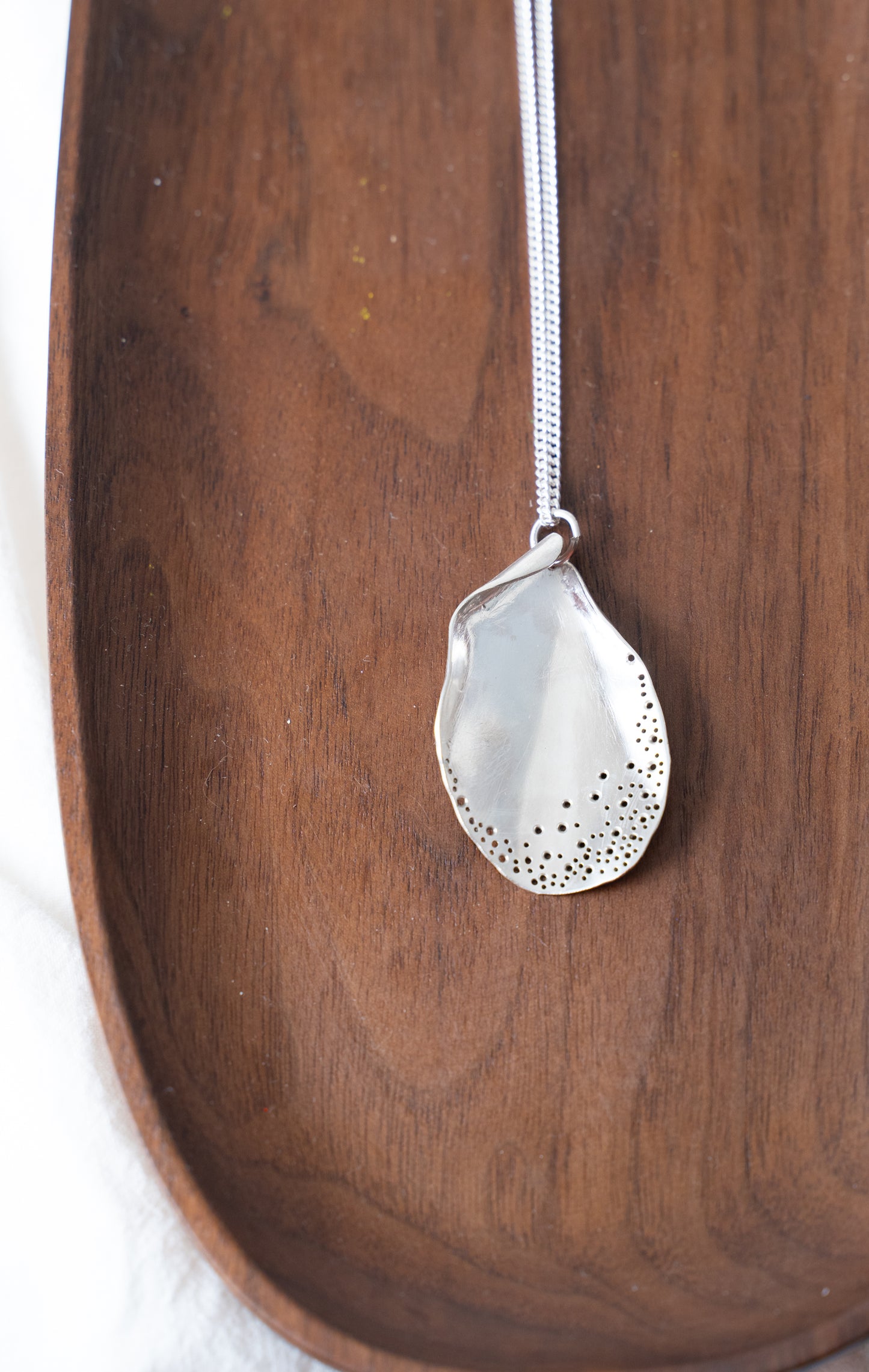 Long oyster-inspired, hand-fabricated, silver pendant and chain