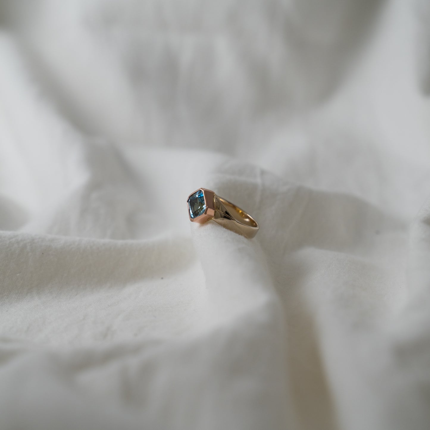 Double blue aquamarine set in 18k rose gold on a 18k white gold band.