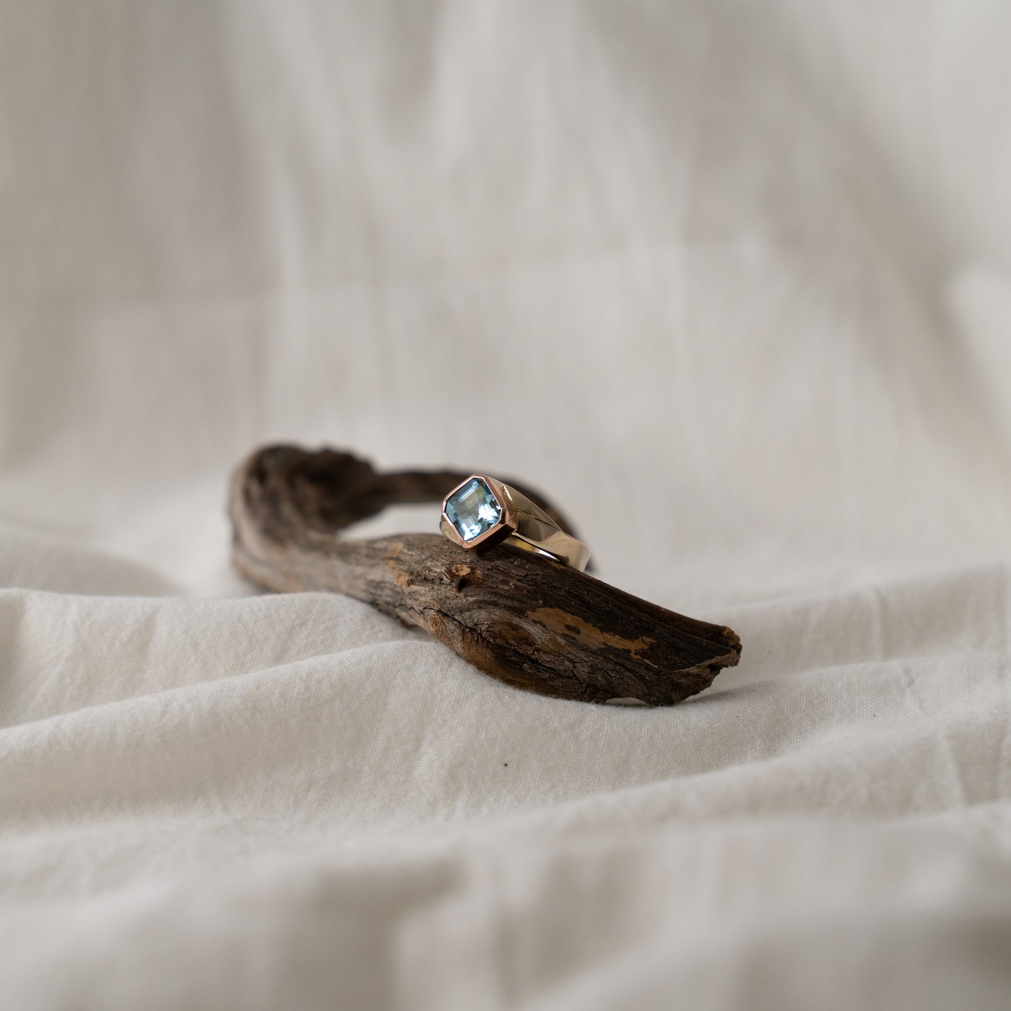 Double blue aquamarine set in 18k rose gold on a 18k white gold band.