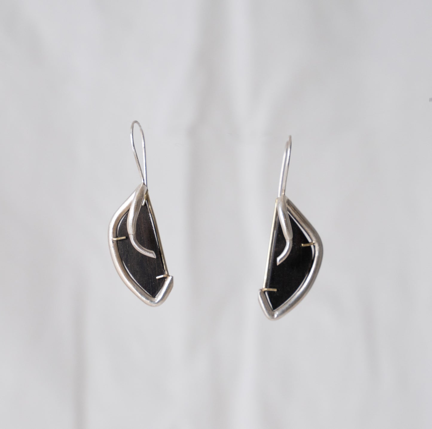 Pronghorn earrings in silver, hand fabricated in sterling silver with ebony wood hand set in 14k yellow gold dangle earrings