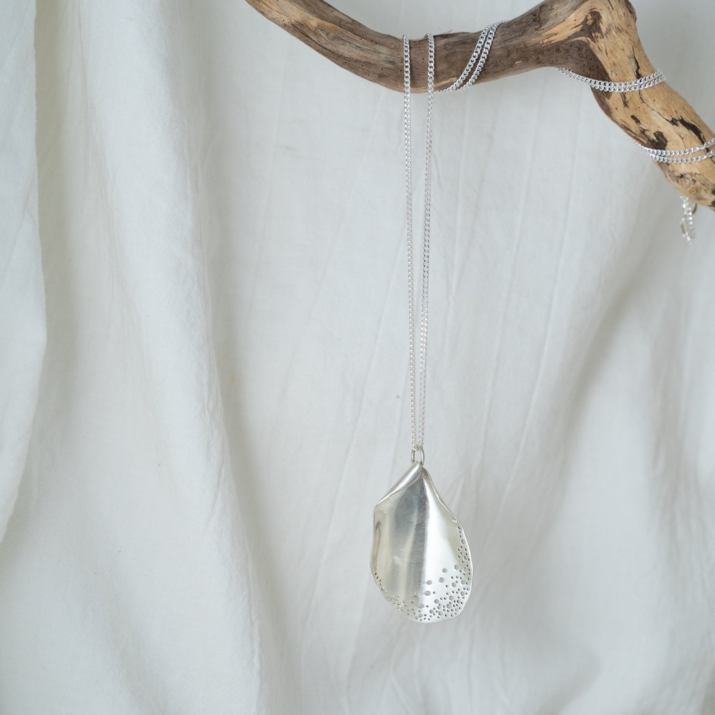Long oyster-inspired, hand-fabricated, silver pendant and chain