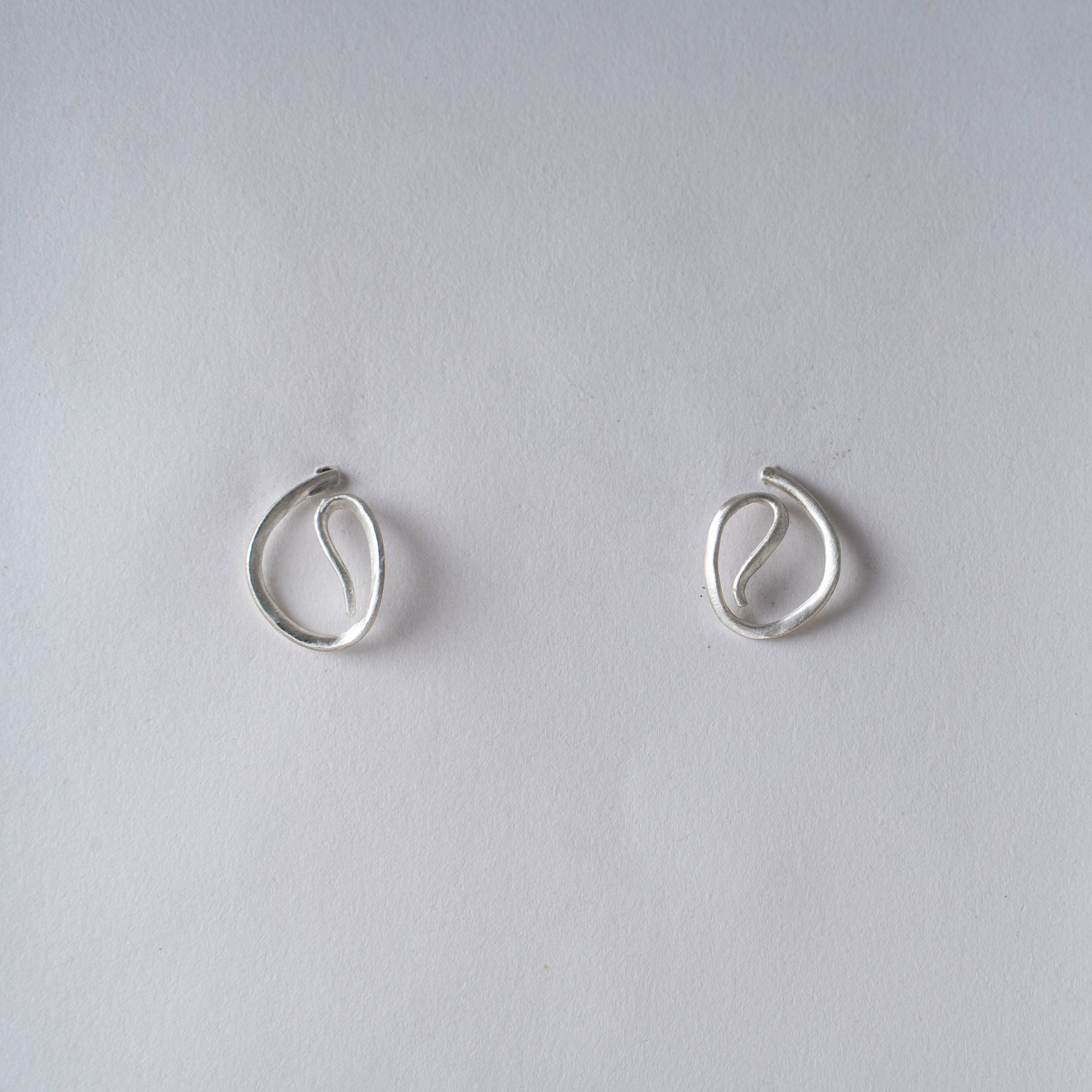 Pair of silver hoop earrings on a white background