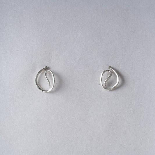 Pair of silver hoop earrings on a white background