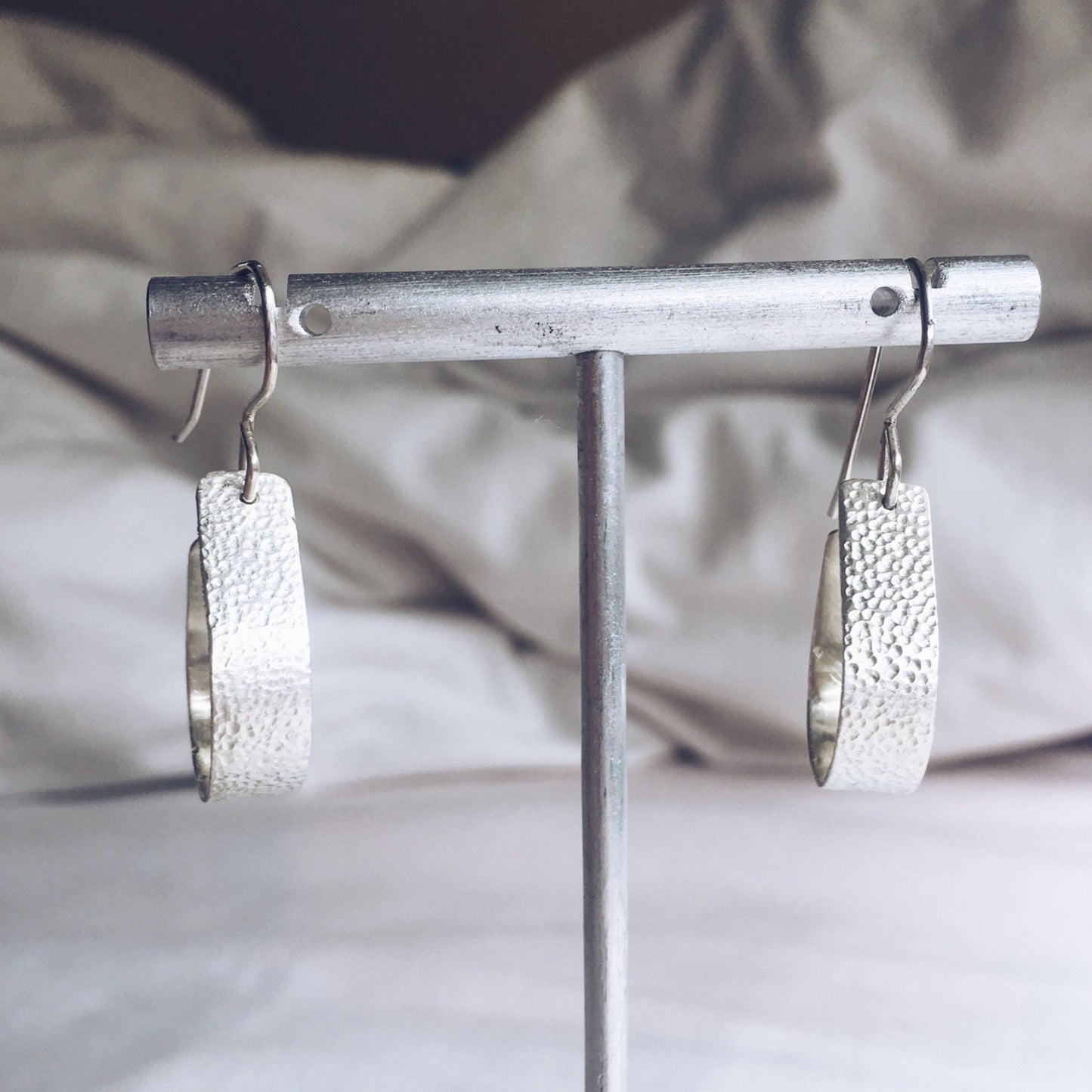 Bohemian with a hammered textured finish, silver, handcrafted open, teardrop, hoop earrings.