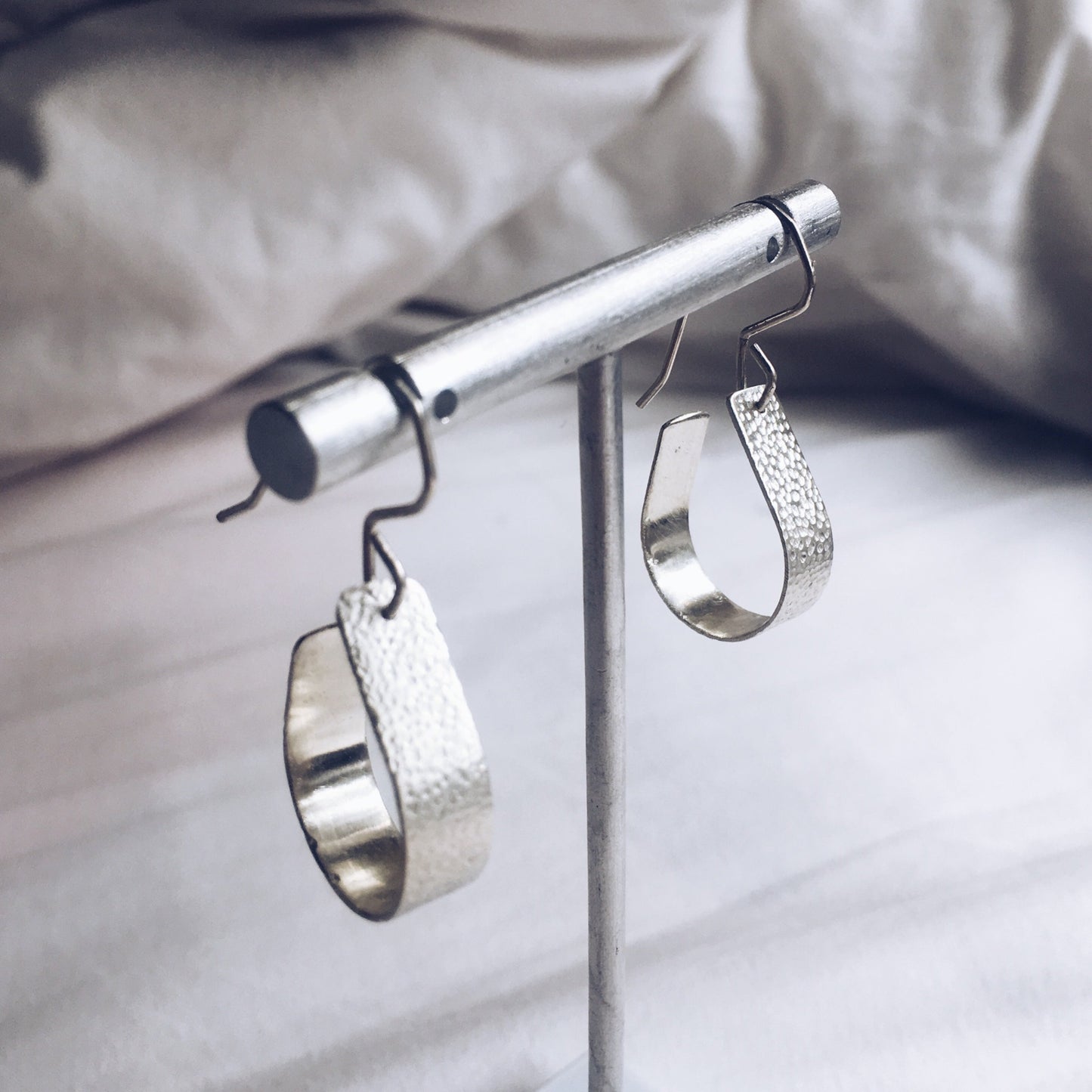 Bohemian with a hammered textured finish, silver, handcrafted open, teardrop, hoop earrings.