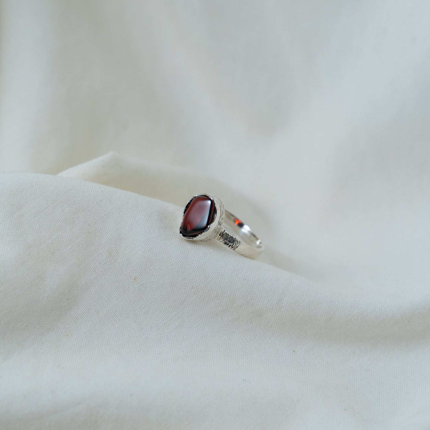Textured, silver, garnet cabochon ring