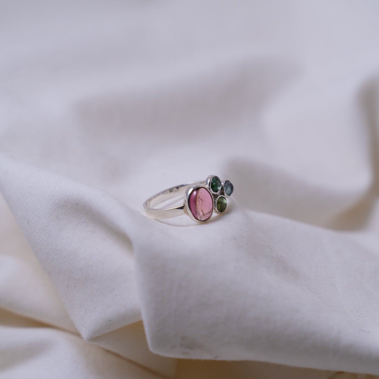 Hand fabricated pink and green tourmaline ring with a tanzanite cabochon set in silver