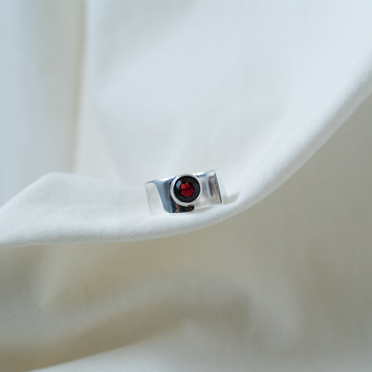 Round cut garnet, open sterling silver ring