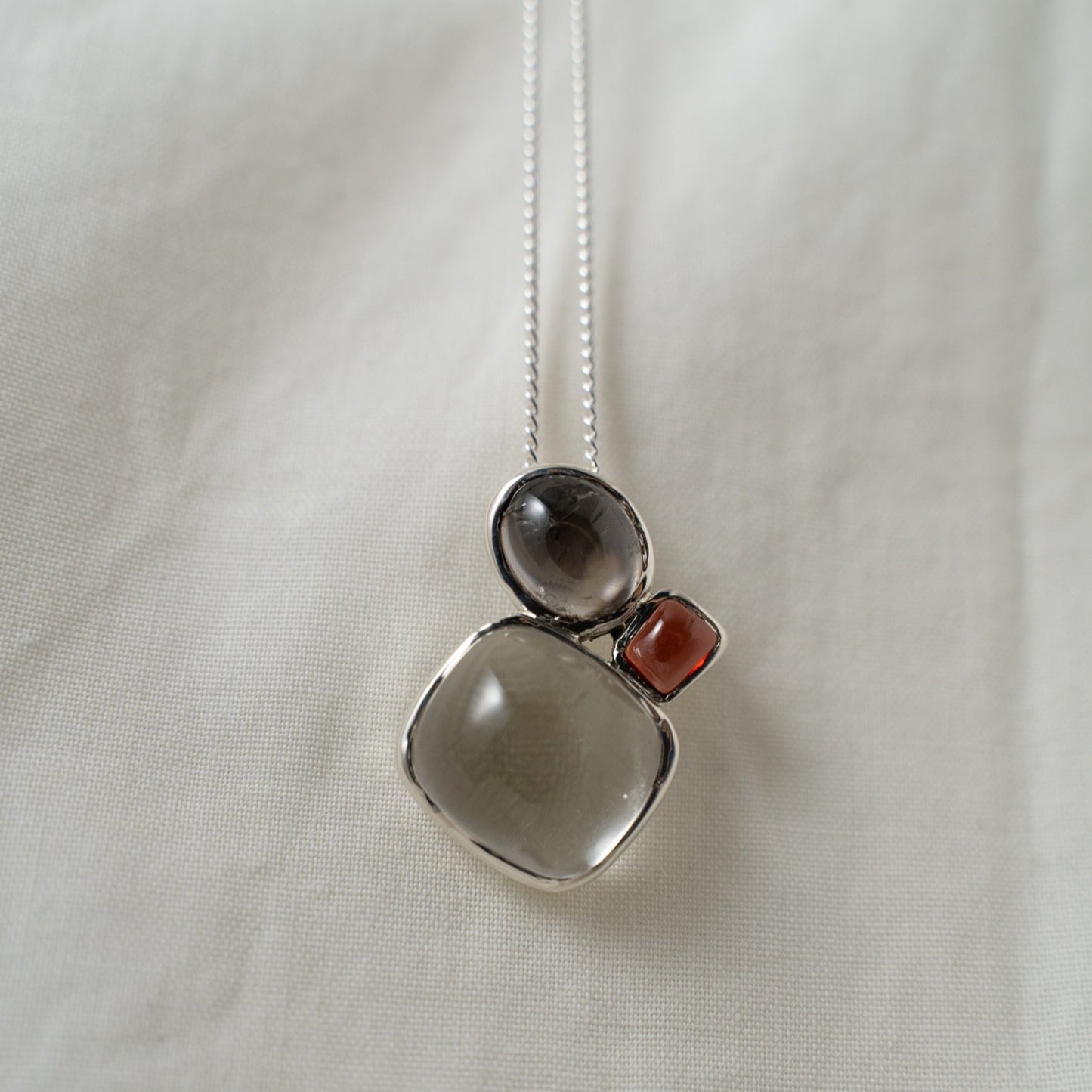 quartz, smokey quartz and garnet silver pendant