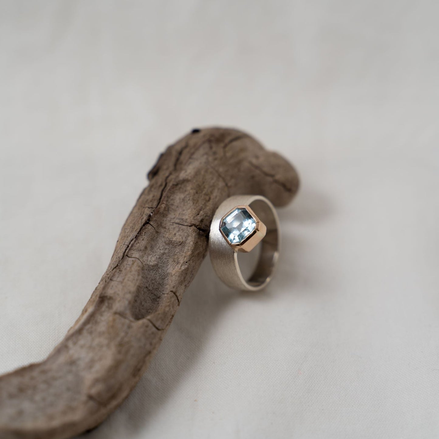 Asscher cut aquamarine set in gold on a silver ring