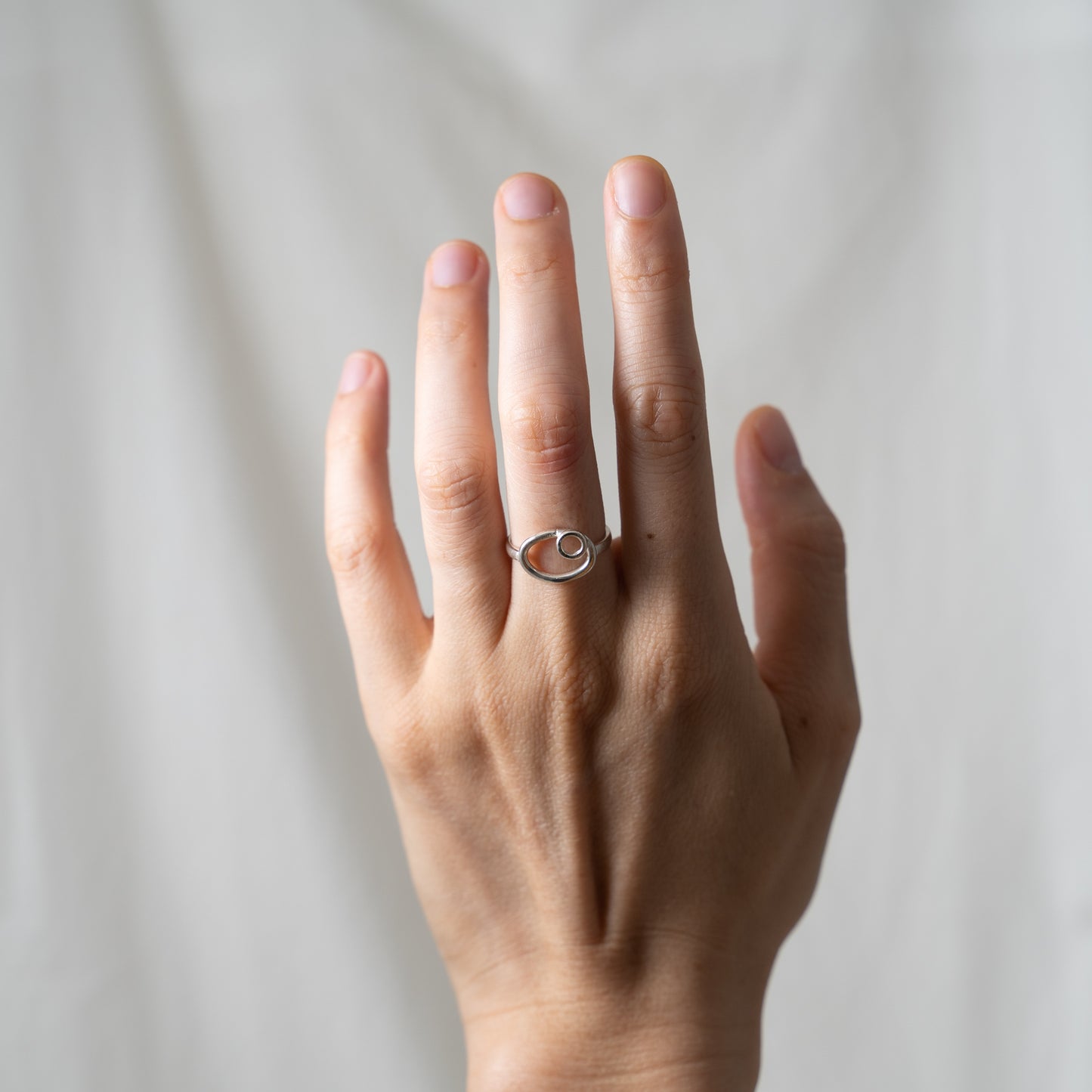 Dual oval and circle, small silver ring