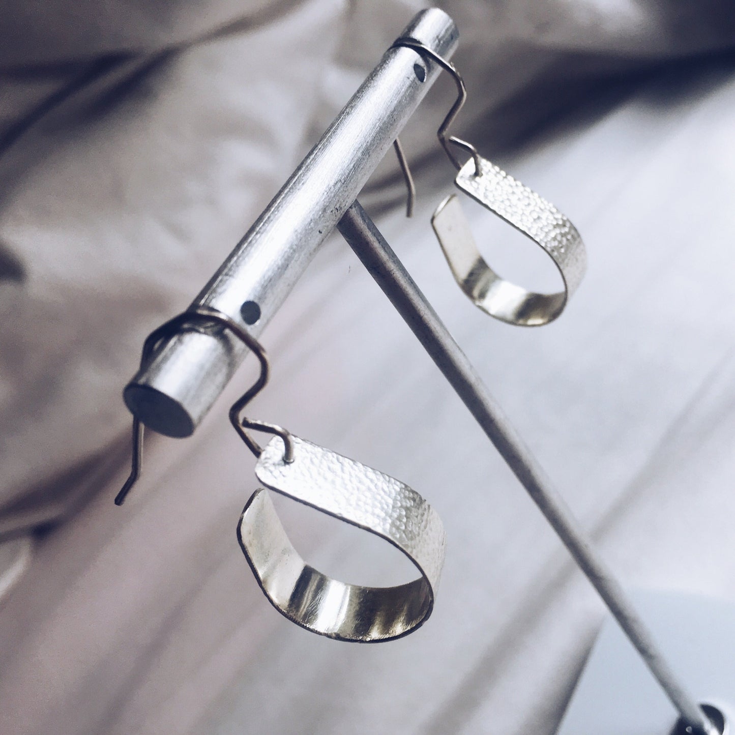 Bohemian with a hammered textured finish, silver, handcrafted open, teardrop, hoop earrings.