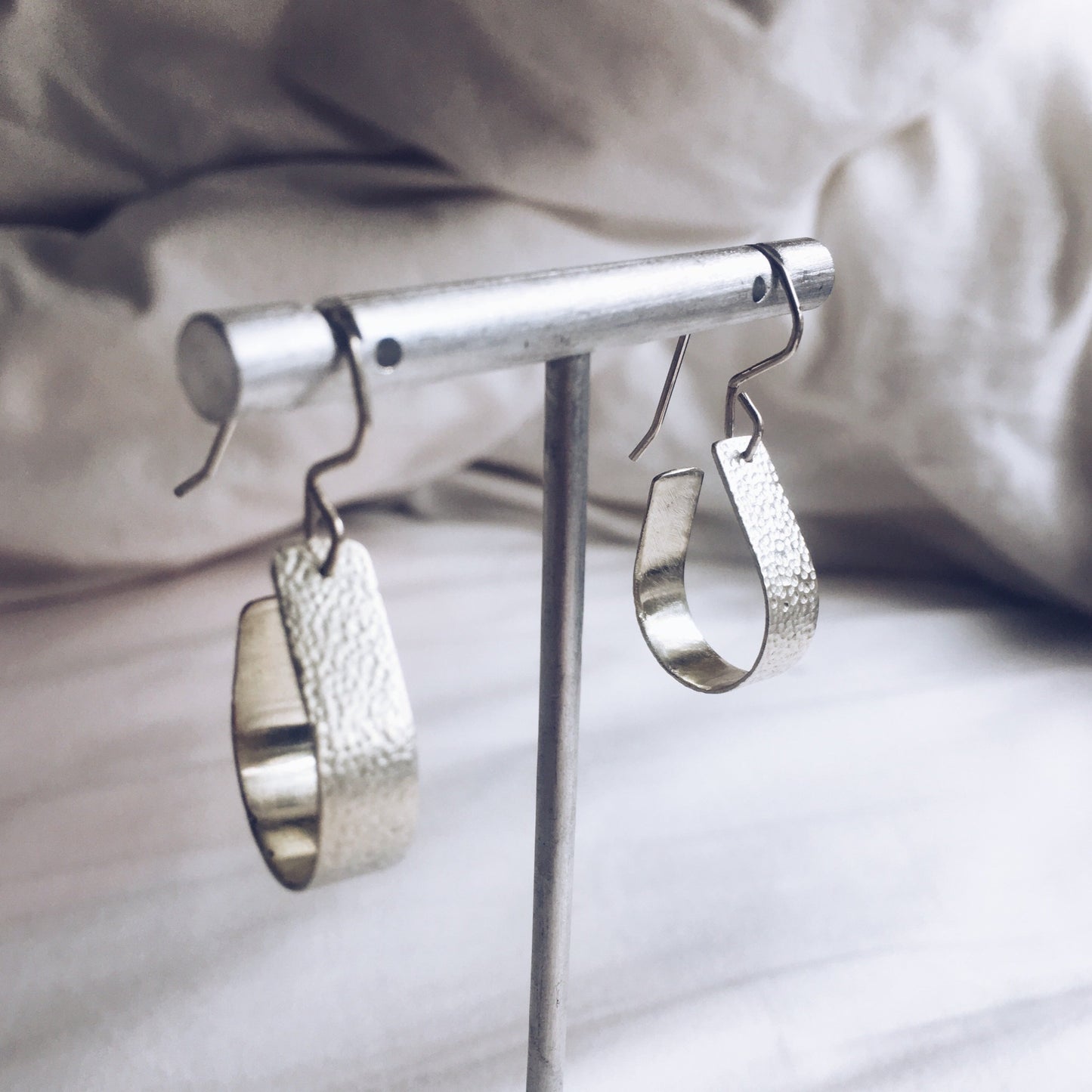 Bohemian with a hammered textured finish, silver, handcrafted open, teardrop, hoop earrings.