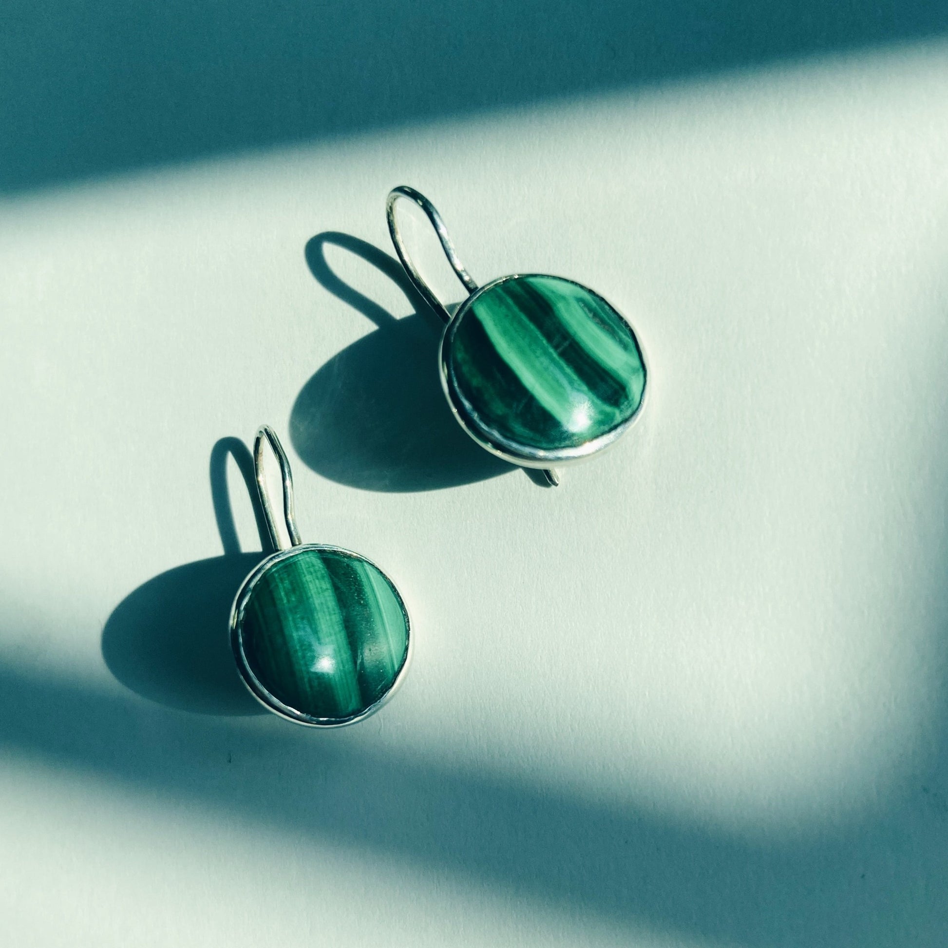 Handcrafted, small, round malachite earrings in silver.