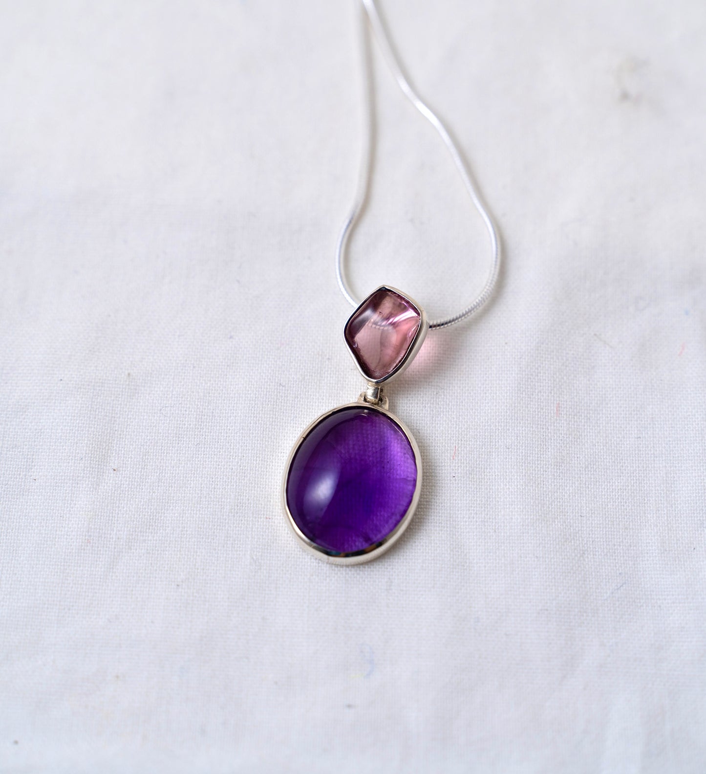 Handcrafted Amethyst and Pink Tourmaline Pendant: Elegant Gemstone Contrast