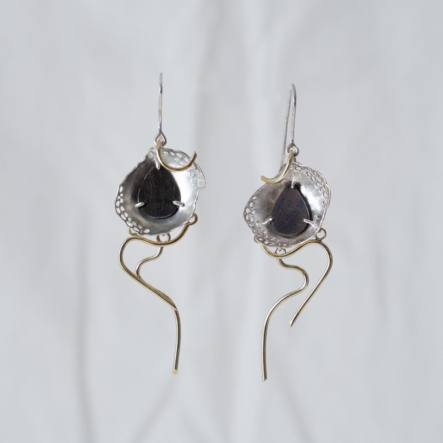 Hiding beneath the flowers, hand fabricated 14k yellow gold with ebony wood hand set in sterling silver dangle earrings