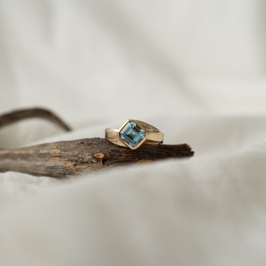 Double blue aquamarine set in 18k rose gold on a 18k white gold band.