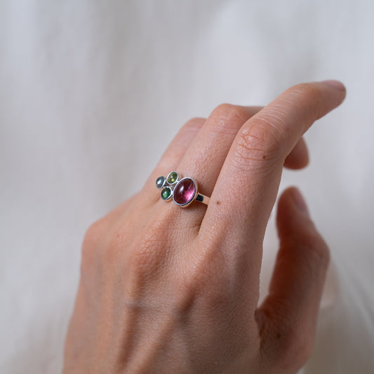 Hand fabricated pink and green tourmaline ring with a tanzanite cabochon set in silver