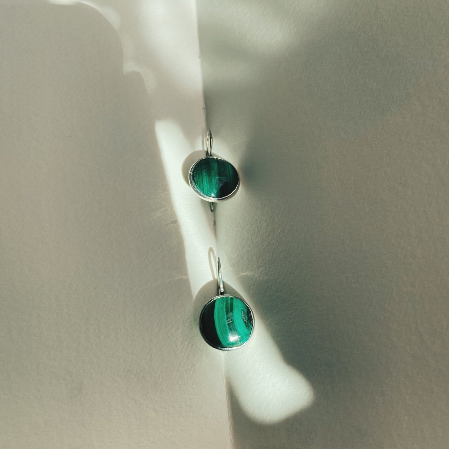 Lovely dangle, emerald green like malachite earrings with vertical dark green lines running down the length of the malachite. 